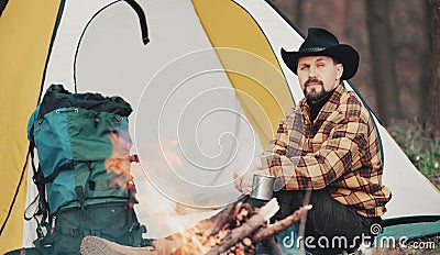 Man having tea at campfire Stock Photo