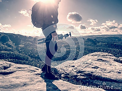 Creator and photographer is setting up tripod for standing on rock Stock Photo