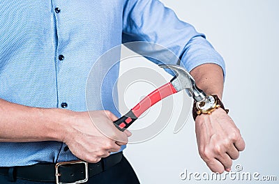 Man cropped view break wrist watch device with claw hammer tool, kill time Stock Photo