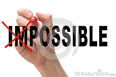 Man crossing out the letters `im` from the word impossible. Stock Photo