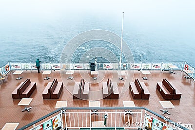 Man on the cruise liner looking on the sea on cloudy sky Editorial Stock Photo