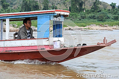 Man cruising on a boat in river Mekong Editorial Stock Photo