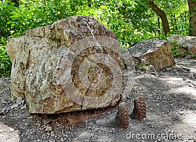 Man crushed underneath rock Stock Photo