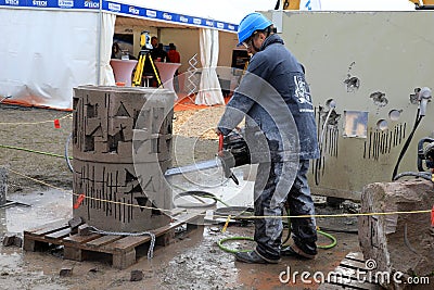 Man Cuts Concrete with ICS Chain Saw Editorial Stock Photo
