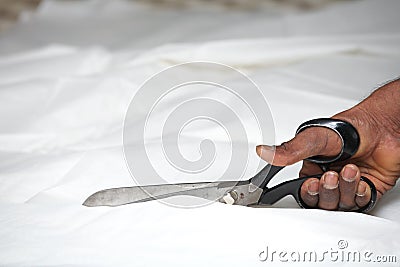 Man cutting fabric Stock Photo