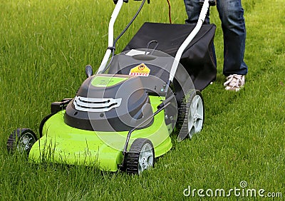 Man cutting the grass with lawn mower Stock Photo