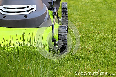 Man cutting the grass with lawn mower Stock Photo
