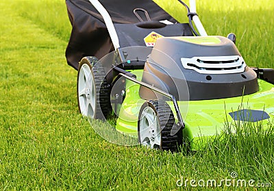 Man cutting the grass with lawn mower Stock Photo