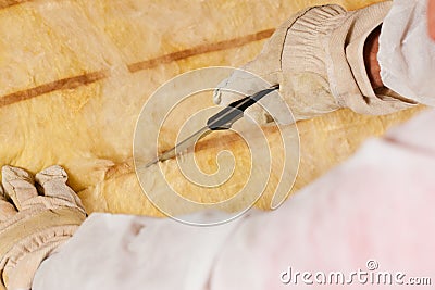 Man cutting insulation material for building Stock Photo