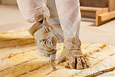 Man cutting insulation material for building Stock Photo