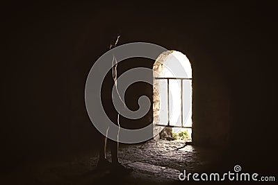 Man in the dark enlightened by sun in mysterious castle. Stock Photo