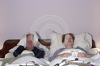 Man Dealing with Snoring Wife Stock Photo