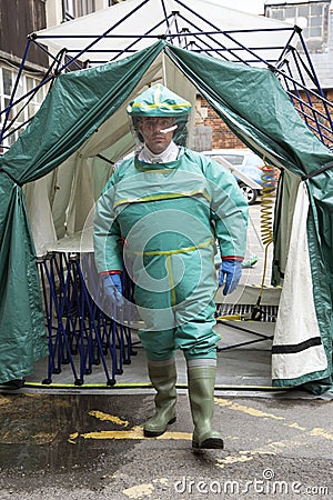 Man in decontamination suit exiting a tent Editorial Stock Photo