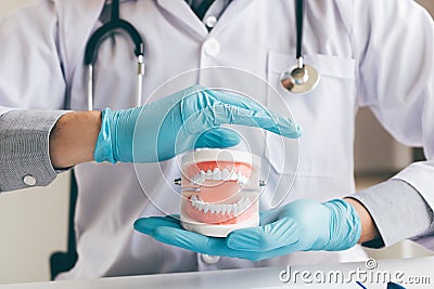 Man dentist asian hand protecting the dentures. Stock Photo