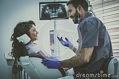 Man dentist having discussion wit patient. Stock Photo