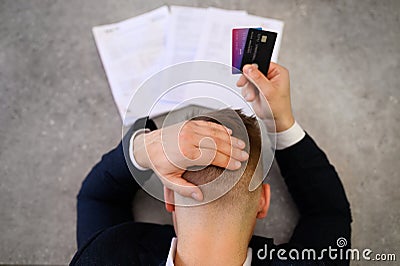 Man in desperation with credit card debt Stock Photo