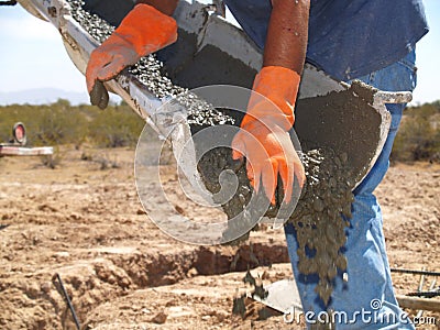 Man Directing Cement From Spout - Horizontal Stock Photo