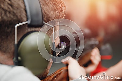 Man directs firearm gun pistol at target firing range or shooting range Stock Photo