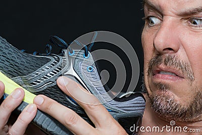 Man Disgusted By Shoes Smell Stock Photo