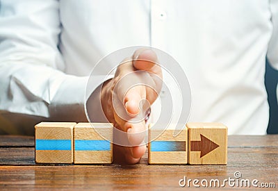 Man divides the arrow blocks into two parts. Interruption of the process, decreased activity. Stop financing and supply, slowing Stock Photo