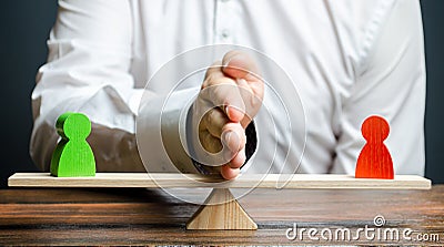 A man divides with his palm two figures of people of opponents on the scales. To reason and settle the conflict between Stock Photo