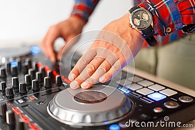 Man DJ plays on the mixing console close-up Stock Photo