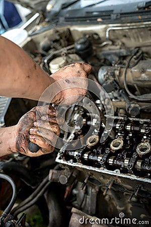 A man does a broach of the head. Makes car repair, engine malfunctioning Stock Photo