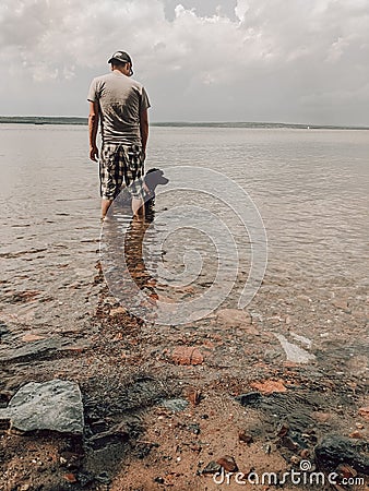 Man & Dog in Clear Shallow Water at Chequamegon Bay in Wisconsin Stock Photo