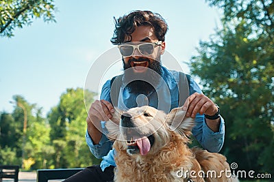 Man and dog having fun, playing, making funny faces while restin Stock Photo