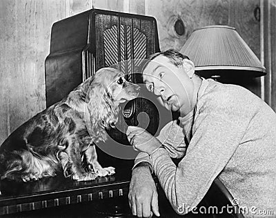 Man and dog listening to the radio Stock Photo