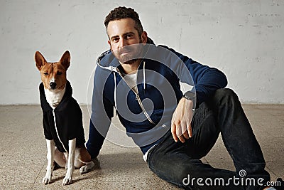 Man and dog in matching hoodies Stock Photo