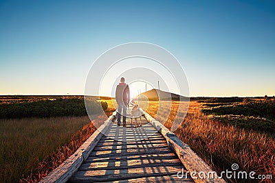 Man with dog on the trip in the mountains Stock Photo