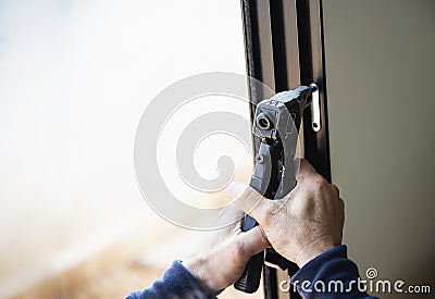 Man doing aluminum frame with glasses and wire screen door and window Stock Photo
