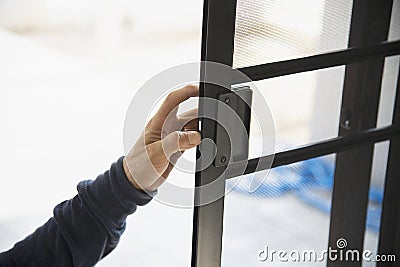 Man doing aluminum frame with glasses and wire screen door and window Stock Photo