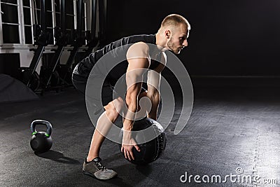 Man Doing Exercise With Medicine Ball Stock Photo