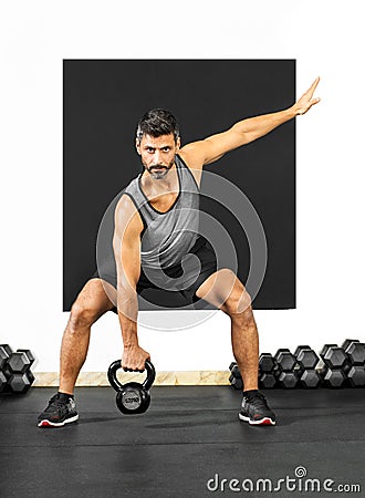 Man doing exercises with a kettlebell weight Stock Photo