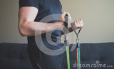 Man doing exercises with resistance bands. Stock Photo