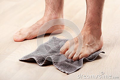 Man doing flatfoot correction gymnastic exercise grabbing towel at home Stock Photo