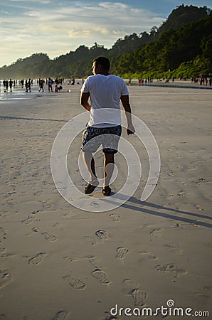 Man Doing a Funny Walk On a Beach Stock Photo