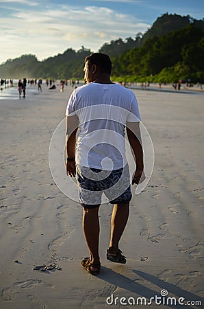 Man Doing a Funny Walk On a Beach Stock Photo