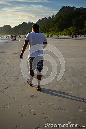 Man Doing a Funny Walk On a Beach Stock Photo