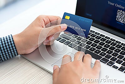 Man doing online shopping with credit card on laptop Stock Photo