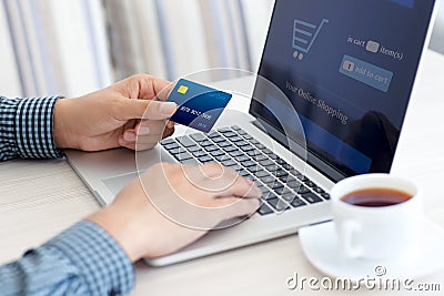 Man doing online shopping with credit card on laptop Stock Photo