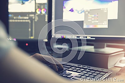 Man doing photo and video editing on computer Stock Photo