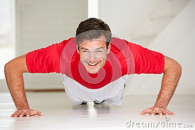 Man doing push-ups in home gym Stock Photo