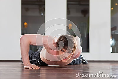 Man doing pushups in gym Stock Photo