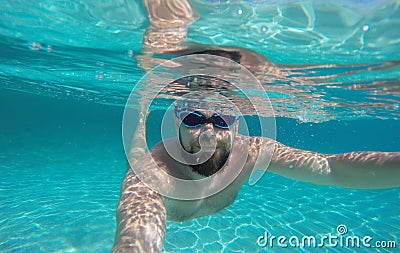 Man doing underwater selfie shot in deep blue sea Stock Photo