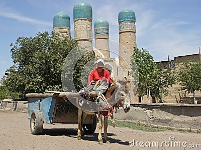 Man and Donkey in front of madrassa Chor Minor, Bukhara, Uzbekistan Editorial Stock Photo