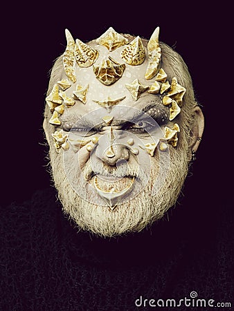 Man with dragon skin and beard Stock Photo