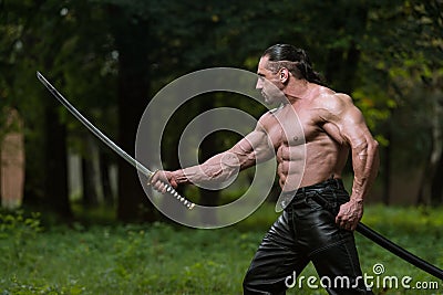 Man Drawing Ancient Sword In Self Defense Stock Photo